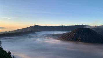 a beautiful view of the mountains surrounded by clouds and mist in the morning video