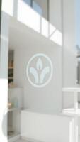 Minimalist white logo on glass door with blurred background photo