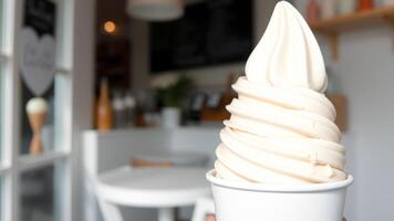 Close-up of a Soft Serve Ice Cream Cone in a White Cup photo