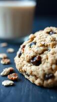 Closeup of a chewy chocolate chip cookie with milk in the background photo