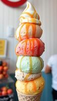 Multi-colored ice cream cone with caramel sauce photo