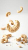 Cashew nuts falling on white background photo