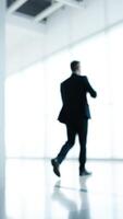 Blurred Silhouette of a Man Walking in an Office photo