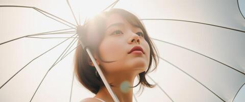 Woman looking up at the sun with a transparent umbrella photo