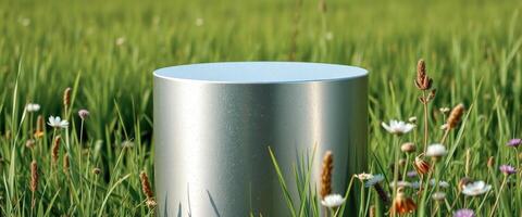 Silver Cylinder Product Display in a Field of Green Grass and Flowers photo