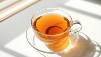 Cup of Tea on White Surface with Sunbeams photo