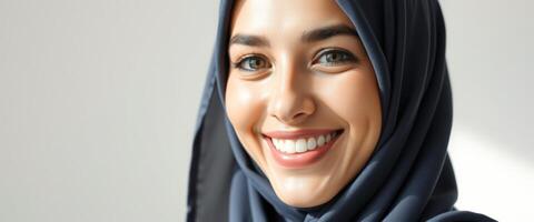 Close-up portrait of a smiling woman wearing a hijab photo