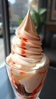 Closeup of a Soft Serve Ice Cream Sundae with Strawberry Sauce photo