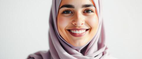 Close-up portrait of a smiling woman in a hijab photo