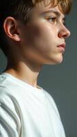 Portrait of a young boy looking away, profile, close-up photo