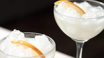 Closeup of two glasses of refreshing drinks with ice and lemon slices photo