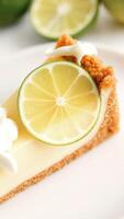 Close-up of a slice of Key lime pie with a lime wedge photo