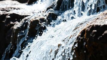 Close-up of water cascading over rocks photo