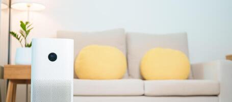 Air Purifier in cozy living room. Purification system for filter and cleaning or removing dust PM2.5 HEPA and virus in home. Allergy, Pure air, health lifestyle, Wellness life and Air Pollution photo
