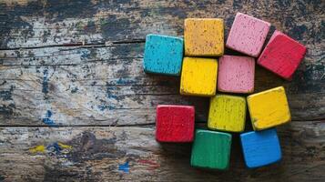 Colorful Wooden Cube Blocks Stacked on Rustic Wooden Surface photo