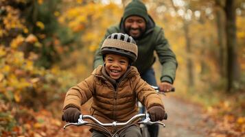 Joyful Father and Son Riding Bike on Autumn Forest Path photo