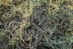 background of colored threads chaotically intertwined. green yellow and brown threads matted in a colorful background photo