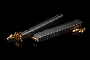 Pistol cartridges 9 mm on a smooth glossy surface with reflections. Ammunition for pistols and PCC carbines on a dark back. photo