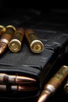 Bullet isolated on black background with reflexion. Rifle bullets close-up on black back. Cartridges for rifle and carbine on a black. photo