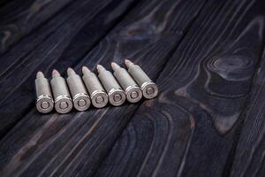 Cartridges on a wooden black background photo