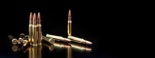 Bullet isolated on black background with reflexion. Rifle bullets close-up on black back. Cartridges for rifle and carbine on a black. photo