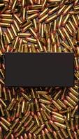 Background from cartridges 9 mm. Dark box in the middle of pistol cartridges. Blank for a poster or banner photo