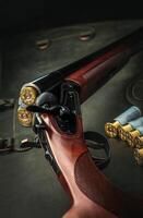 Classic trigger double-barreled hunting rifle on a green background. Smooth-bore hunting rifle open for reloading. Concept postcards for hunters. photo