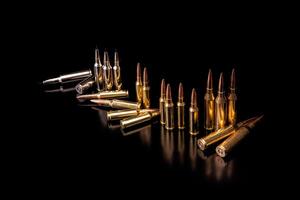 Bullet isolated on black background with reflexion. Rifle bullets close-up on black back. Cartridges for rifle and carbine on a black. photo