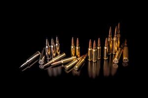 Bullet isolated on black background with reflexion. Rifle bullets close-up on black back. Cartridges for rifle and carbine on a black. photo
