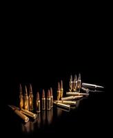 Bullet isolated on black background with reflexion. Rifle bullets close-up on black back. Cartridges for rifle and carbine on a black. photo