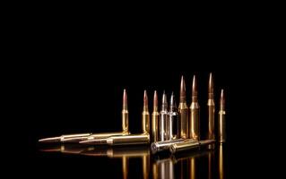 Bullet isolated on black background with reflexion. Rifle bullets close-up on black back. Cartridges for rifle and carbine on a black. photo