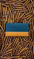 Background from rifle cartridges on a gray metal back. A box of cartridges. Copy space for text in the center of the image in the form of a rectangle. photo