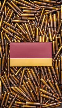 Background from rifle cartridges on a gray metal back. A box of cartridges. Copy space for text in the center of the image in the form of a rectangle. photo