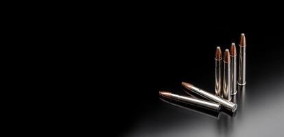 Bullet isolated on black background with reflexion. Rifle bullets close-up on black back. Cartridges for rifle and carbine on a black. photo