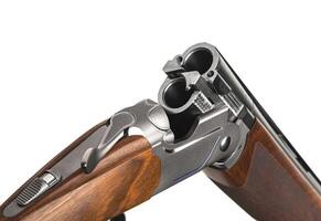 Double-barreled shotgun isolate on a white back. Smooth-bore weapons with vertical barrels. A sporting or hunting shotgun with a wooden stock. photo