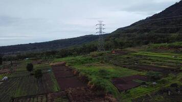 The drone's forward aerial motion captures the path of electricity in cloudy weather video