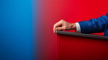Closeup of a candidates hand gripping a podium gradient background shifting from blue to red intense focus space for text photo