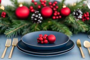 Christmas and New Year table settings in deep blue and vibrant red with accents of pale yellow and seafoam green highlights photo