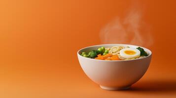 Cozy bowl of miso ramen with autumn vegetables, soft boiled egg, and rich broth, steam rising against a gradient background blending from warm orange to deep brown photo