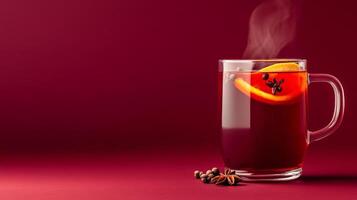 Cozy mulled wine with red wine, cloves, and orange slices, steam rising from the glass mug, warm autumn hues on a gradient background transitioning from deep burgundy to golden amber photo