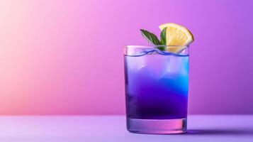 Exotic cocktail with butterfly pea flower tea, gin, and lemon, shifting from deep blue to vibrant purple in a glass, served against a gradient background fading from indigo to soft lavender photo