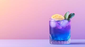 Exotic cocktail with butterfly pea flower tea, gin, and lemon, shifting from deep blue to vibrant purple in a glass, served against a gradient background fading from indigo to soft lavender photo