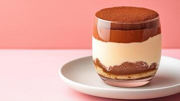 Exquisite dessert of layered tiramisu in a glass, dusted with cocoa powder, placed on a white plate with clear empty space for text, warm gradient background photo