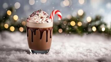 Frosty peppermint mocha with candy cane garnish, whipped cream, and chocolate drizzle, placed on a snowy table with frosted evergreen branches and soft winter bokeh in the background photo