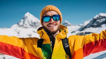 Happy snowboarder with outstretched arms embracing the winter resort scene snow capped peaks in the background colorful jacket contrasting with the white snow pure exhilaration photo
