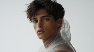 Slim model in an avant garde fashion look draped in sheer fabrics fluid movement minimalist set muted tones capturing modern androgyny with soft elegance photo