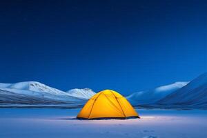 Tent nestled in snowy mountain landscape under a starlit sky photo