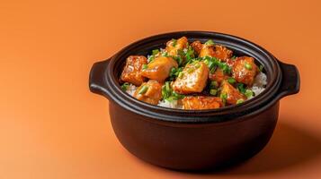 Vietnamese autumn dish of caramelized claypot fish with ginger and green onions, served with warm rice, set on a gradient background fading from deep orange to brown photo