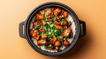 Vietnamese autumn dish of caramelized claypot fish with ginger and green onions, served with warm rice, set on a gradient background fading from deep orange to brown photo