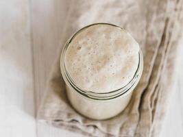 Wheat sourdough starter, top view, copy space photo